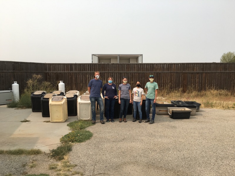 The Peregrine Fund's California Condor Propagation Team stand in front of empty travel crates after receiving evacuated birds from Oregon Zoo.