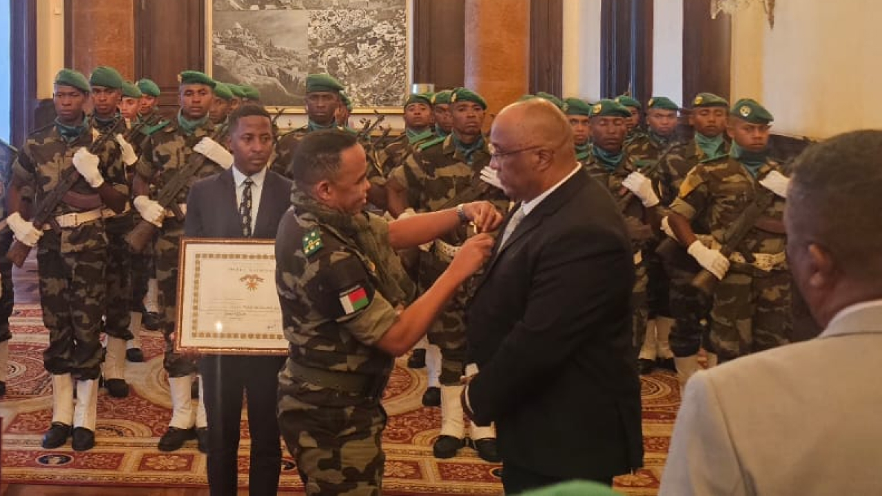 Dr. Lily-Arison René de Roland receiving a certificate of recognition from the President of Madagascar.