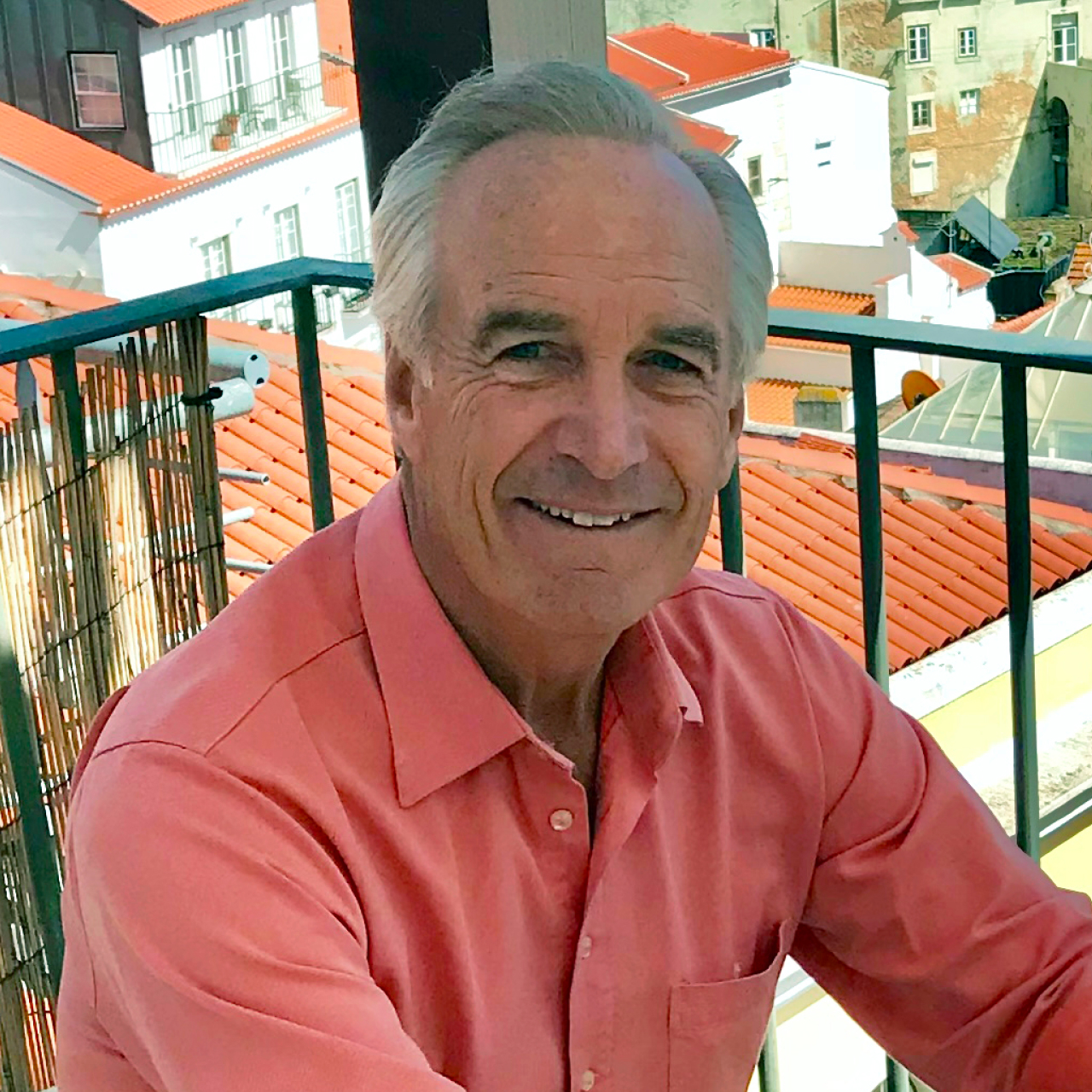 Dirk Kempthorne posing for a photo on a balcony.