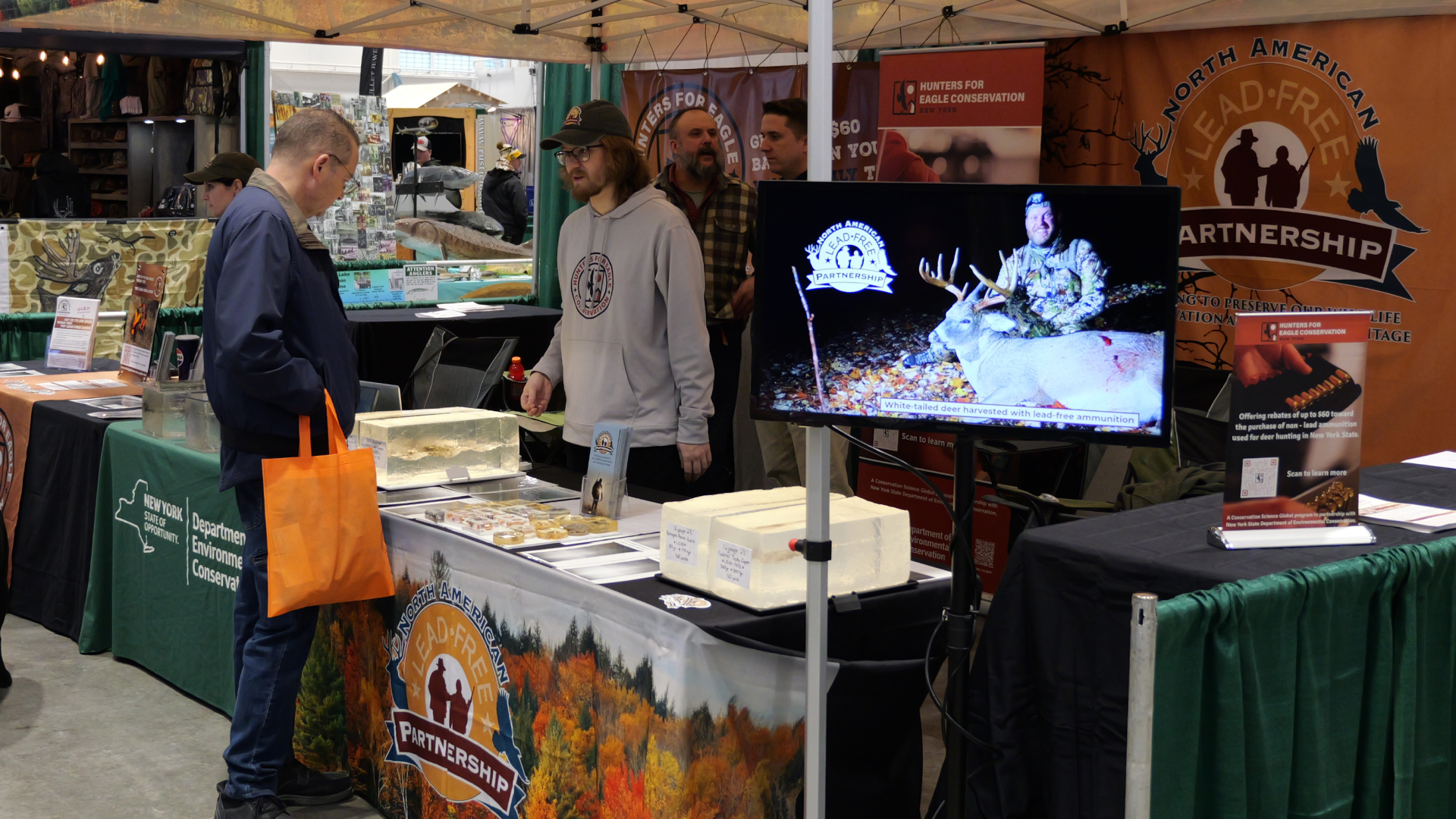 A North American Lead-Free Partnership information tent at a convention.