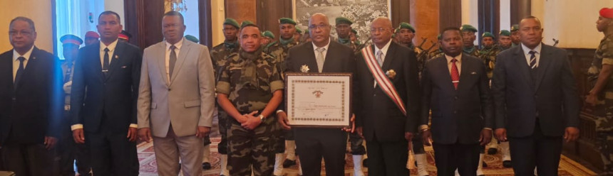 Lily-Arison René de Roland posing with attendees of a ceremony where he received a national certificate of recognition from the President of Madagascar.
