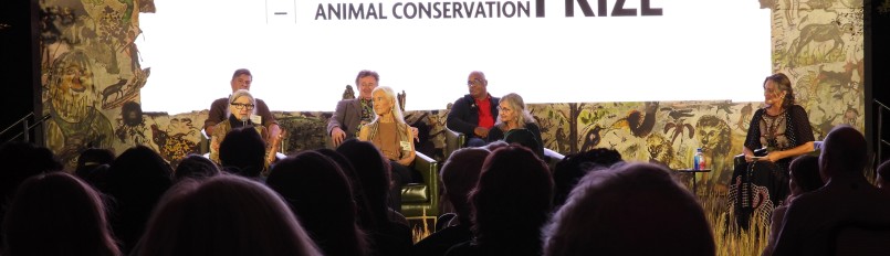 Lily and other awardees on stage during a forum.