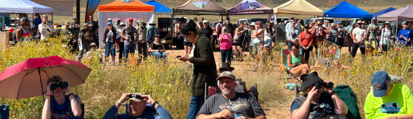 Visitors wait for the condors to depart with pop-up tents and other displays in the background at the in-person event for our 2026 California Condor Release.