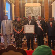 Lily-Arison René de Roland posing with attendees of a ceremony where he received a national certificate of recognition from the President of Madagascar.