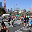 Runners in the Tokyo Marathon passing the Tokyo Tower.