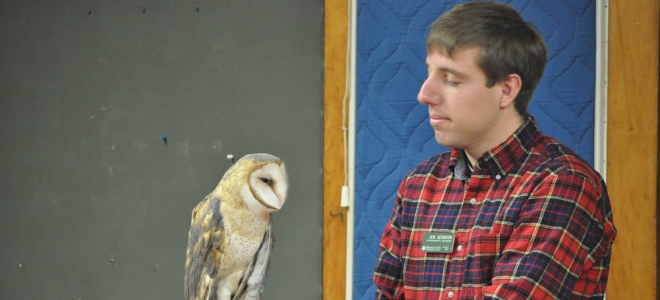 Joe Sebedee holds a barn owl on his arm