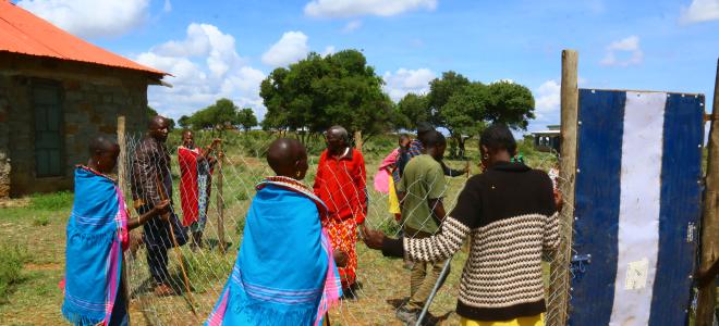 Coexistence co-op trainees learning how to build a better livestock enclosure