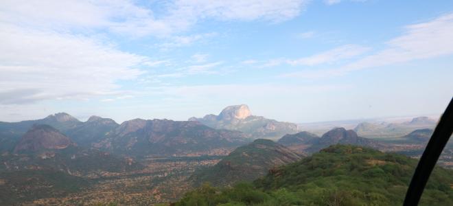 Photo from helicopter of the mountainous and forested landscape of Northern Kenya