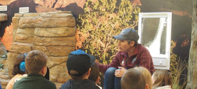 Volunteer Sophia discussing california condor conservation with students