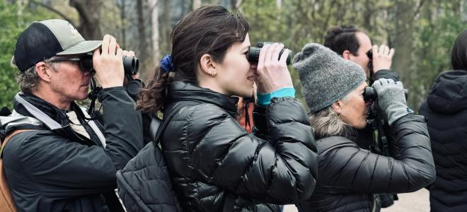 Alicia S and others bird watching through binoculars