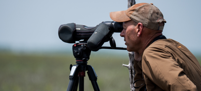 Biologist Brian Mutch looks through scope