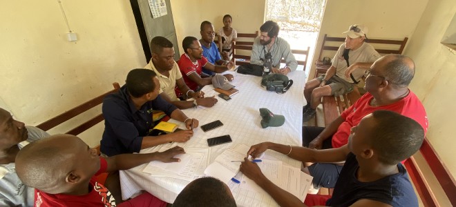 Members of The Peregrine Fund's leadership meet with members of the Madagascar team around a conference table.