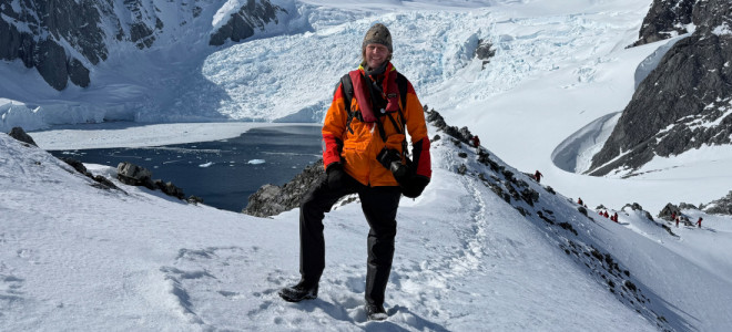 Andrew Orr standing in a snowy, mountainous landscape.