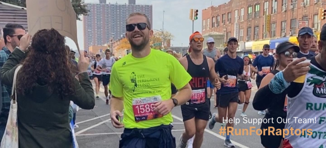 A runner in a Peregrine Fund shirt smiles as he runs past the camera during the TCS NYC Marathon. Overlaid text reads "Help Support Our Team! #RunForRaptors"
