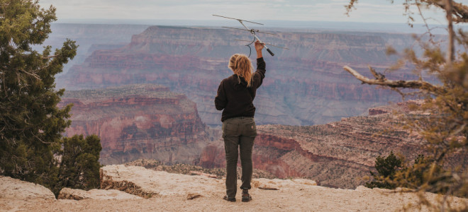 A Peregrine Fund biologist using a radio antenna to track California Condors in the Grand Canyon.