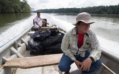 A biologist travels by boat to reach the Darien region of Panama