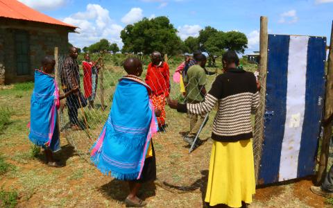 Coexistence co-op trainees learning how to build a better livestock enclosure
