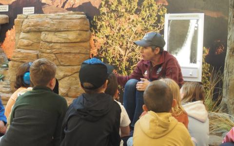 Volunteer Sophia discussing california condor conservation with students