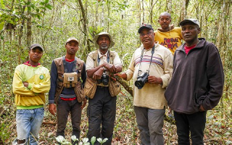 Peregrine Fund Madagascar program staff members posing for a group photo in the forest.