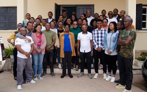 Members of The Peregrine Fund's Madagascar team pose outside a building.