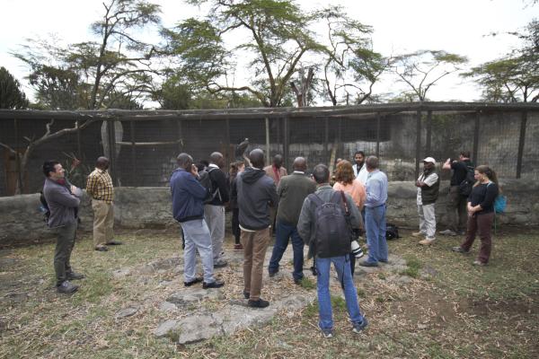 A group of wildlife veterinarians gathered outside at a raptor rehabilitation facility