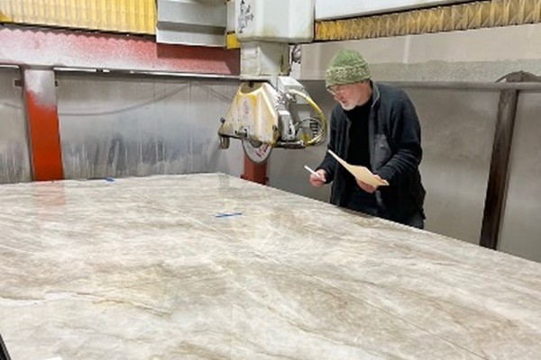 Ross Matteson examining a large slap of quartzite.