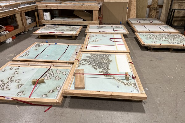 Finished sandblasted stone tiles crated for shipment.