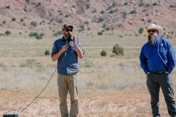 Tim Hauck and Bob Bate speak to the crowd at the in-person event.