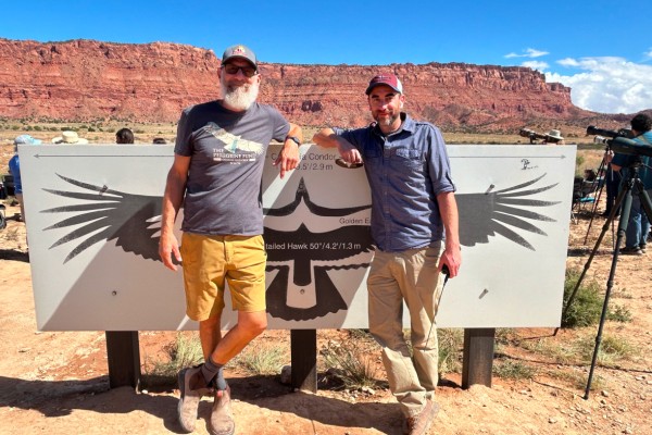 Shawn Farry and Tim Hauck pose in front of an interpretive sign.