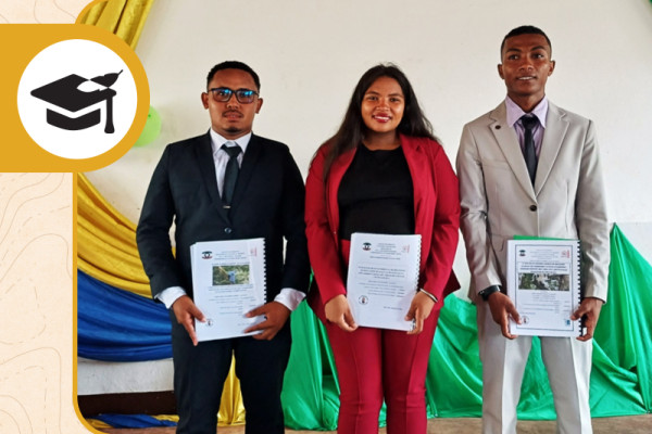 Three graduates supported by our Madagascar Program pose together holding their diplomas.