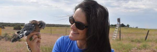 Biologist Sarah Schulwitz holds an American Kestrel