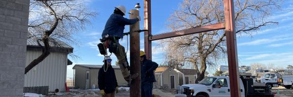 Students from the Northwest Lineman College install a power line in the new Idaho Power Flight Lab exhibit.