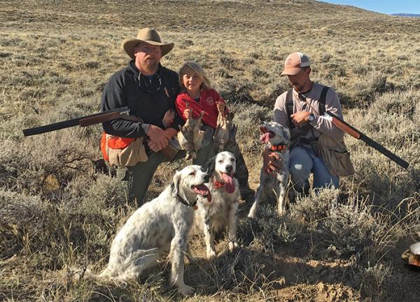 Hunters in the field with dogs