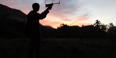 A biologist using telemetry at sunrise