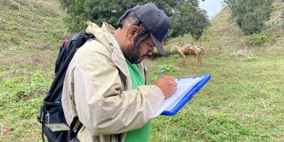 Field biologist taking notes