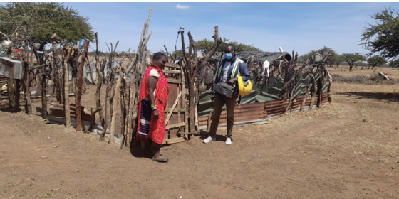 Biologists and local pastoralist standing in front of livestock corral