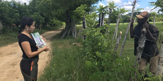 A biologist speaks with a community member