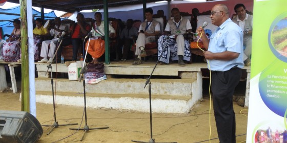 Madagascar Program Director Dr. Lily-Arison Rene de Roland speaking into a microphone in front of a crowd.