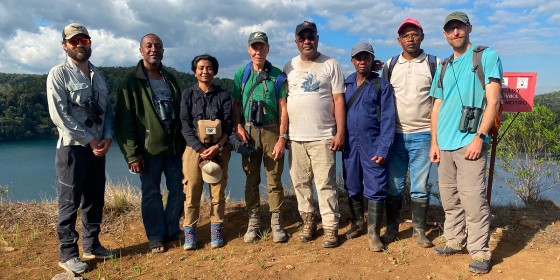 Members of The Peregrine Fund's leadership and Madagascar teams pose for a photo in the field.