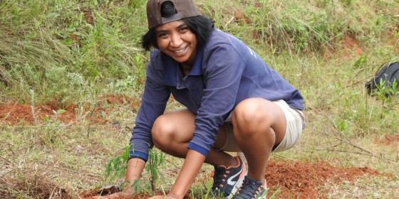 Stéphanie Razakaratrimo squatting on the ground and smiling at the camera.