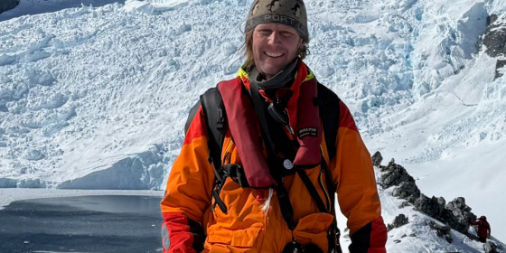 Andrew Orr standing in a snowy, mountainous landscape.