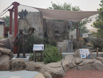 The empty Peregrine Falcon exhibit behind our Welcome Center. The sky is extremely smoky and a sign on the exhibit reads "Bird Off Exhibit."